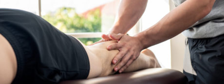 Sports massage therapist helping an athlete 